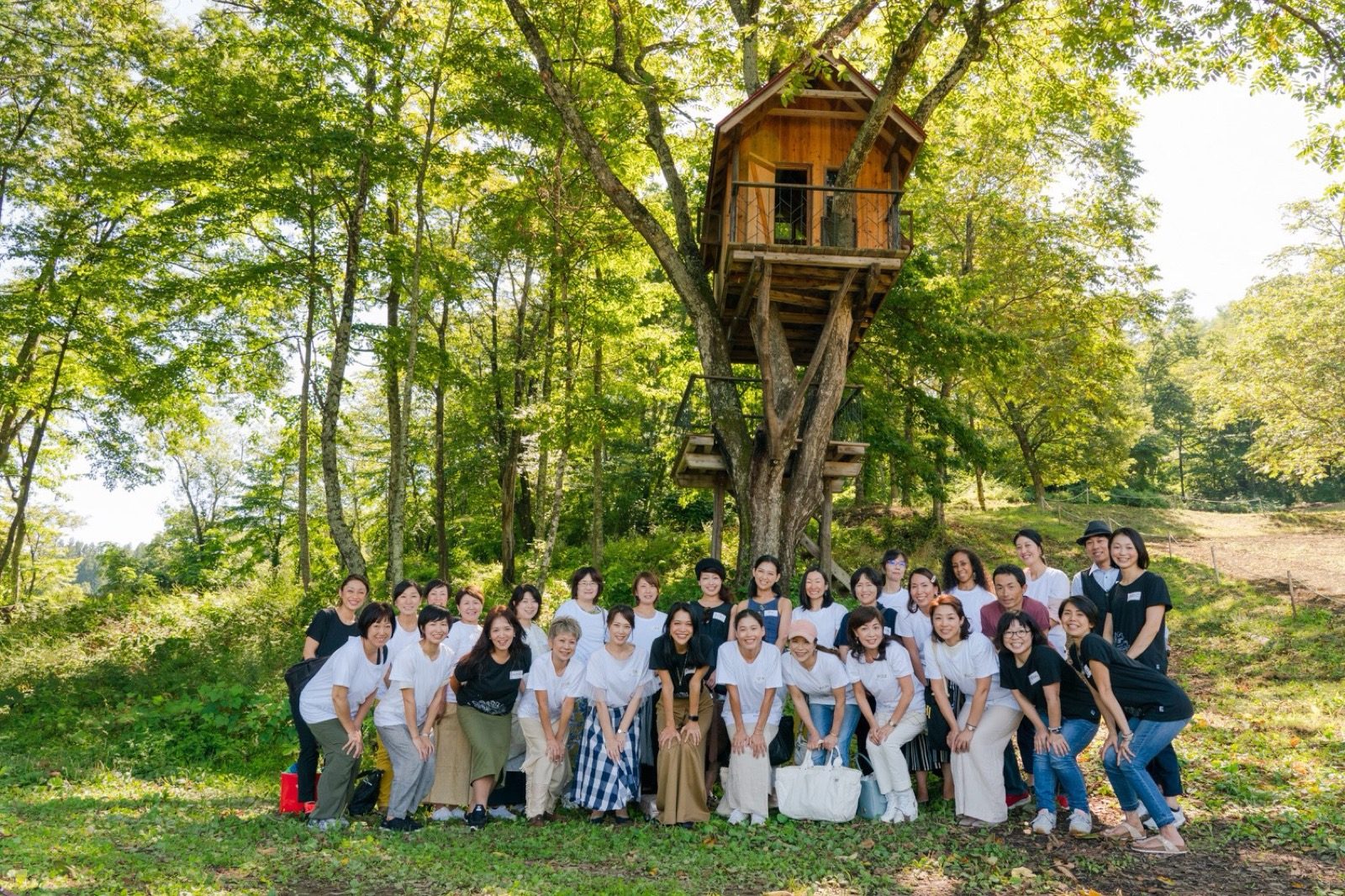 Organic retreat in Nagano, Japan (2019) — participants gathered by a forest treehouse